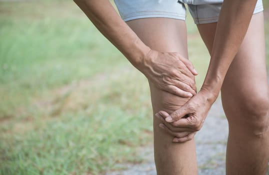The female clings to a bad leg. The pain in her leg. Healthcare and painful concept.