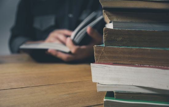 Man reading a book on the table. Education and people concept.