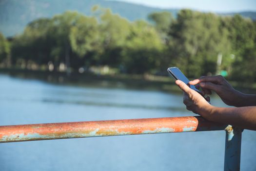 Hand of woman using smartphone, personal chat, and social media.