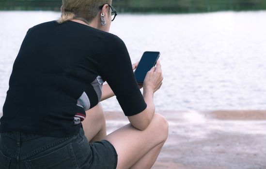 Woman using smartphone, personal chat, and social media.