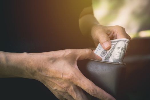 Hand holding a banknote in wallet for financial, accounting and saving money concept.