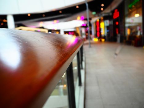 Wooden railing in the shopping mall on blur background with copy space for insert text.
