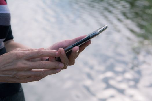Hand of woman using smartphone, personal chat, and social media.