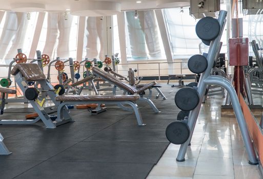 sports equipment and barbells in the gym, interior sports hall