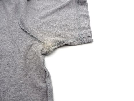 Yellow stain under armpit on T-shirt isolated on white background.