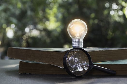 Light bulb and pile of book on table and copy space for insert text.