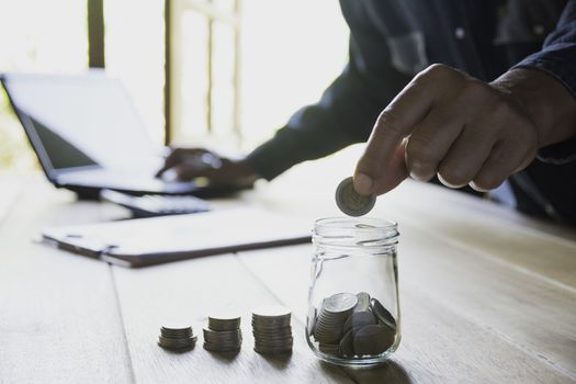 Hand drop a coin with money coin stack growing for business. financial and accounting concept.
