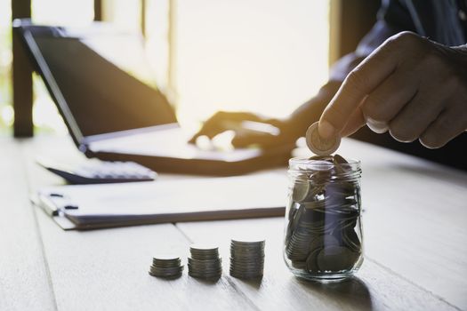 Hand drop a coin with money coin stack growing for business. financial and accounting concept.