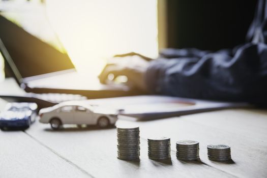 Car insurance and car service. Businesswoman and toy car, business and financial concept.