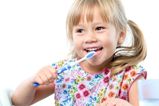 Close up portrait of cute five year old brushing teeth.Isolated on white background.