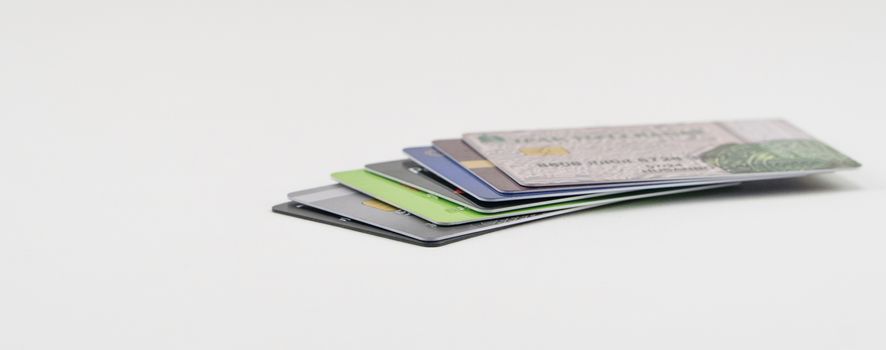 Stack of multi-colored credit cards on a white background. Isolated