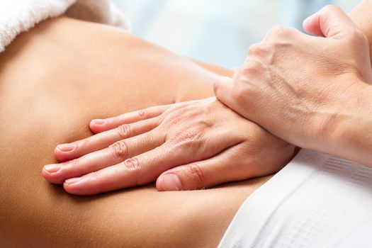 Macro close up of Osteopathic belly massage.