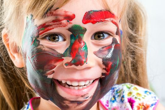 Macro Close up of happy little girl with painted face.