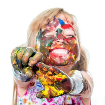 Close up portrait of little girl messed with color paint.Infant with comical behavior.Isolated on white background.