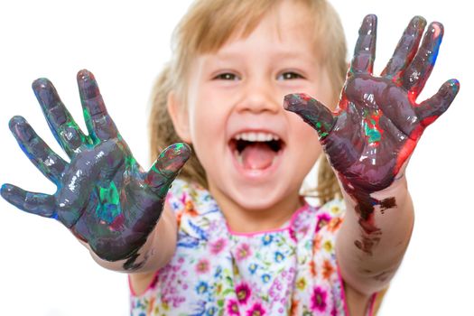 Close up portrait of shouting little girl showing hands messed with color paint.Isolated on white background.