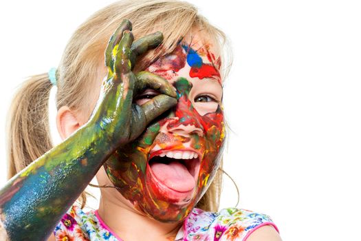 Close up portrait of little girl covered with color paint and open mouth. Face shot of infant doing okay sigh in front of eye.Isolated on white background.