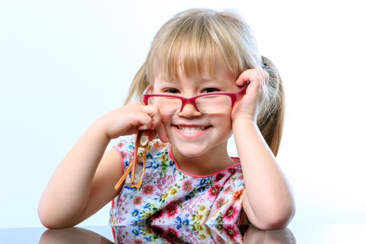 Close up portrait of Funny little girl wearing eyewear on nose.
