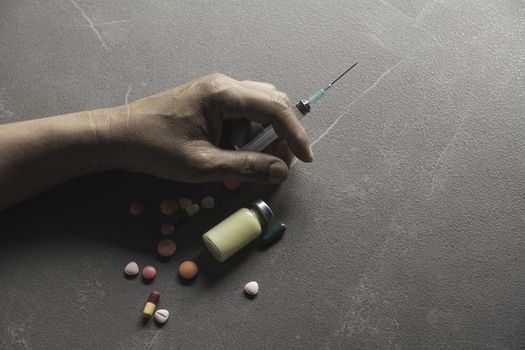 The man committing suicide by overdosing on medication. Close up of overdose pills and addict.