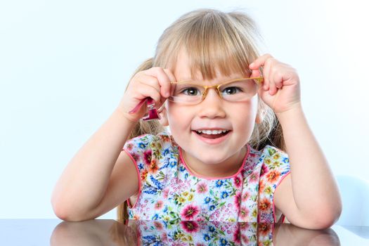 Close up portrait of infant testing new glasses.