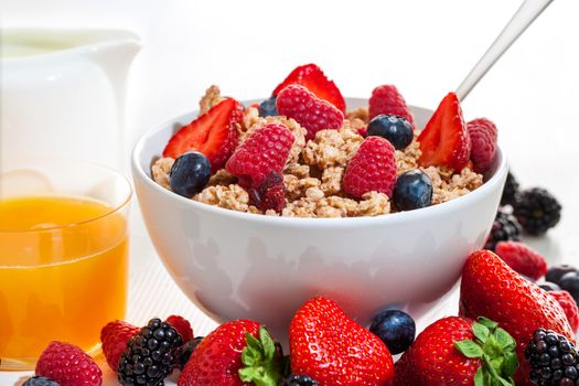 Macro close up of crunchy red Fruit muesli and fresh orange juice.