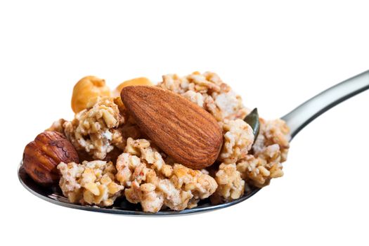 Macro close up of Spoon with mouthful of crunchy muesli and nuts. Isolated on white background.