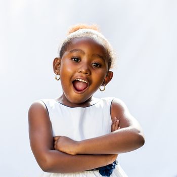 Portrait of cute African girl with surprising face expression.Isolated against light background.
