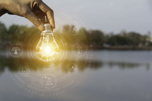 Hand holding a light bulb. Innovation and creative concept.