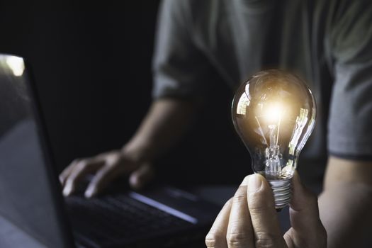 Hand of male holding a light bulb for accounting and creative concept.