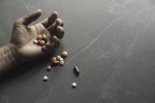 The man committing suicide by overdosing on medication. Close up of overdose pills and addict.
