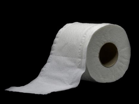 Tissue paper with roll core. Roll of toilet paper isolated on a black background.