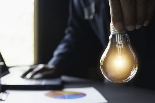 Hand of male holding a light bulb and copy space for accounting, ideas and creative concept.