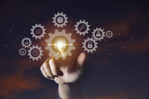 Hand of businessman holding gear icon for technology and business concept.