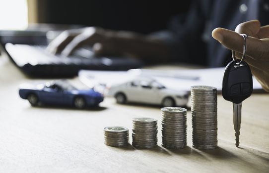 Car insurance and car service with stack of coins. Toy car for accounting and financial concept.