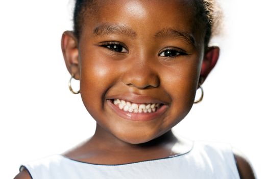 Extreme close up portrait of little african girl showing teeth.Isolated on white background.