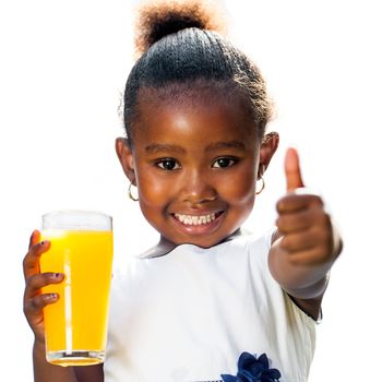 Portrait of cute little African girl doing thumbs up holding orange juice.Isolated on white background.