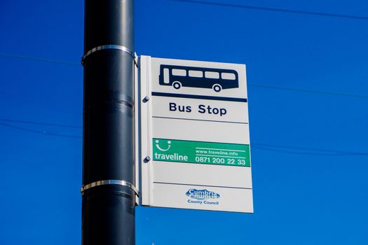 Bus Stop Sign with lovely blue sky behind UK