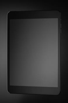 Black a tablet on a dark background closeup