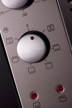 thermostat and handles on a modern microwave, close-up. kitchen equipment