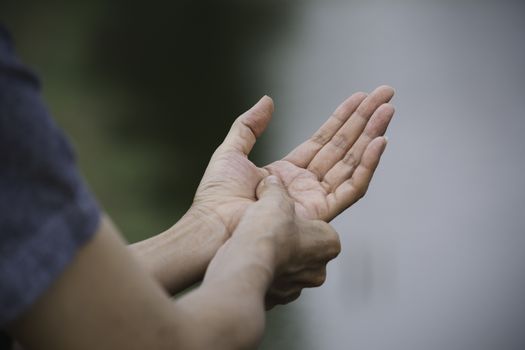 Woman holding her hand. Pain in a woman hand. Female massaging painful hand for painful concept.