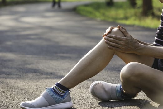 The female clings to a bad leg. The pain in her leg. Health and painful concept.