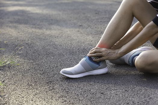 The female clings to a bad leg. The pain in her leg. Health and painful concept.