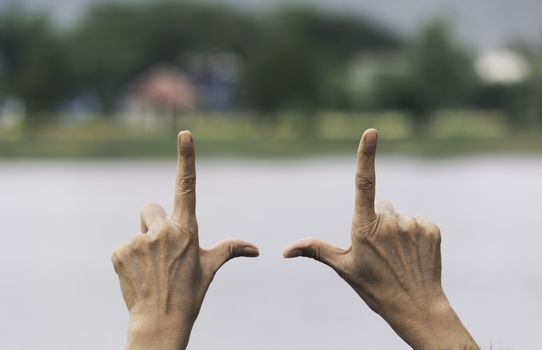 Close up of hands making frame gesture. Close up of woman hands making frame gesture with sunset.