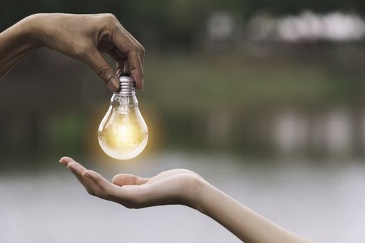 Innovation or creative concept of hand hold a light bulb and copy space for insert text.