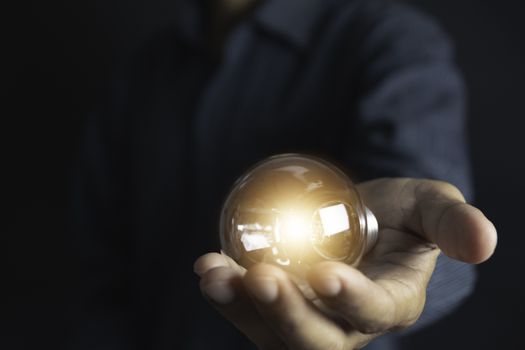 Innovation or creative concept of hand hold a light bulb and copy space for insert text.