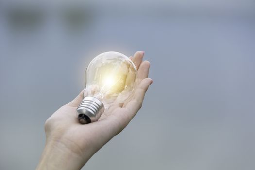 Innovation and creative concept of hand hold a light bulb and copy space for insert text.