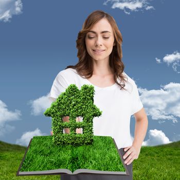 Woman holding lawn book against grass and sky