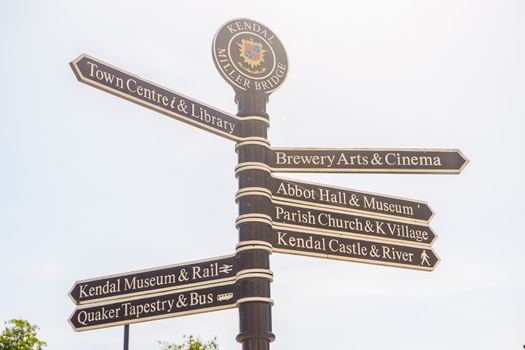 Town signpost showing directions to various places in the center of historical town Kendal. Kendal is considered as the southern gateway to the Lake District, UK