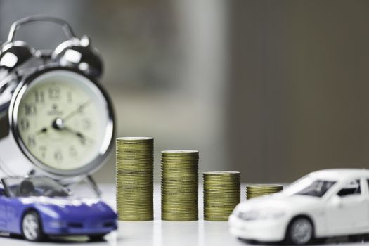 Car insurance and car service. Line graph with stack of coins and toy car, business and financial concept.