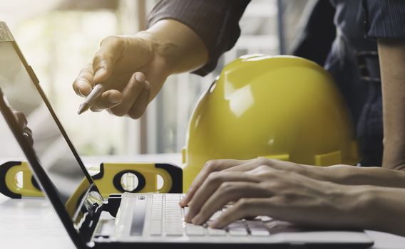 Architect engineer working concept and construction tools or safety equipment on table.