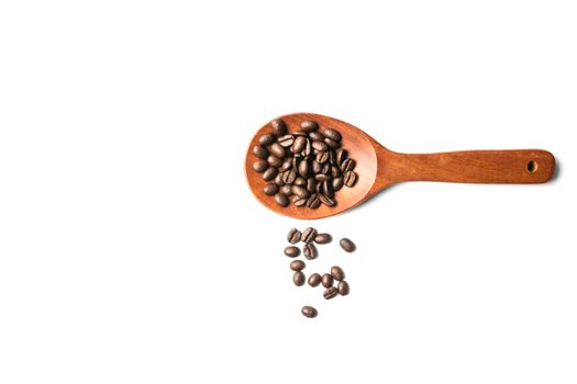 A wooden spoon with spread coffee beans isolated on white background and copy space